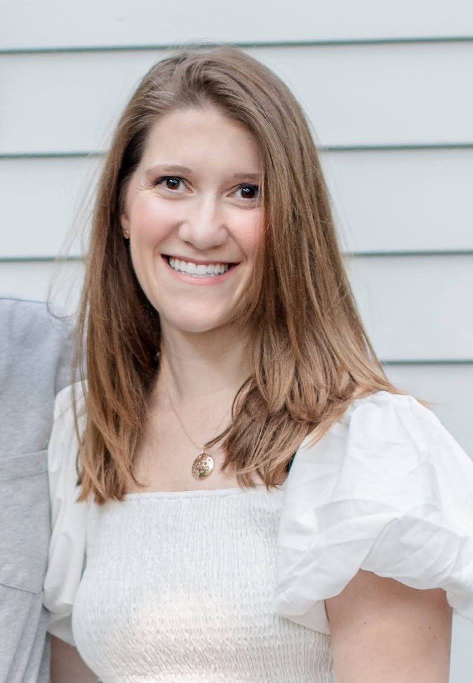 Portrait of Devra Posner, MS, CCC-SLP, smiling outdoors.